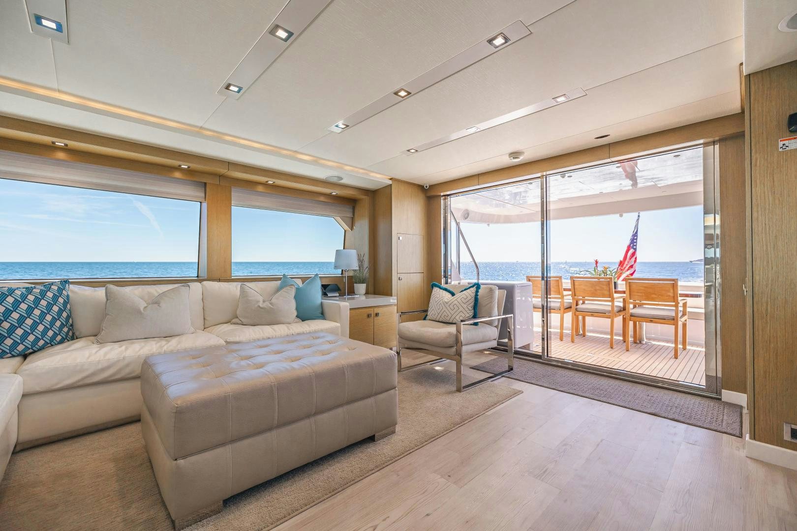 a living room with a couch and a large window aboard BELLA SKY Yacht for Sale