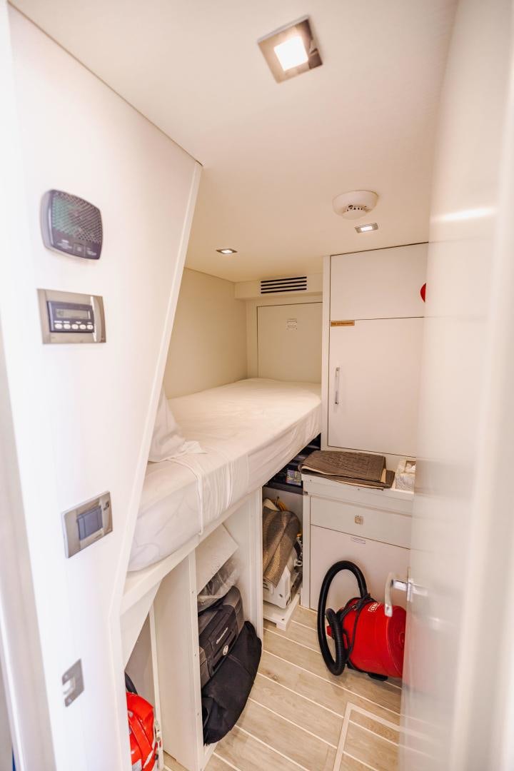 a room with a bed and a chair aboard BELLA SKY Yacht for Sale