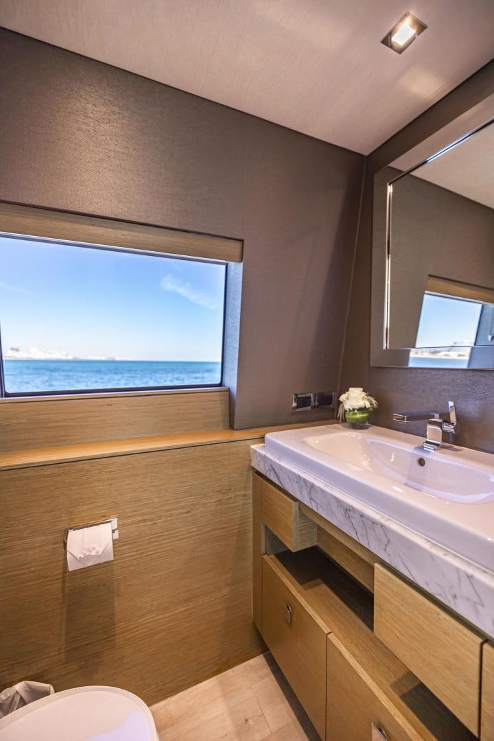 a bathroom with a large window aboard BELLA SKY Yacht for Sale