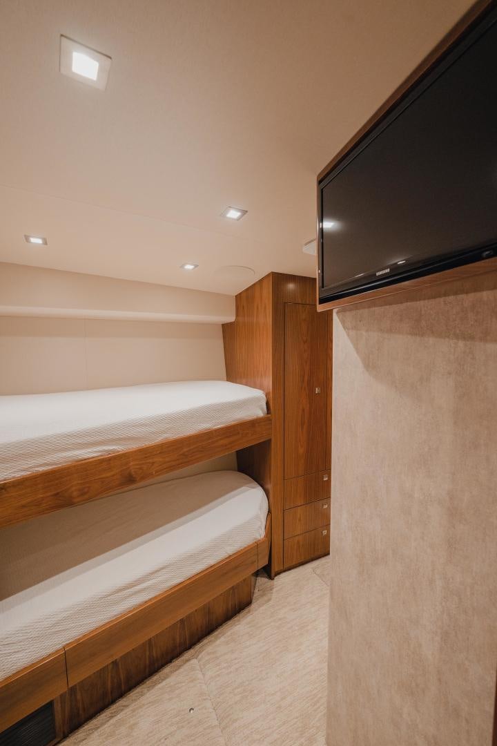 a room with a bed and tv aboard AUSPICIOUS Yacht for Sale