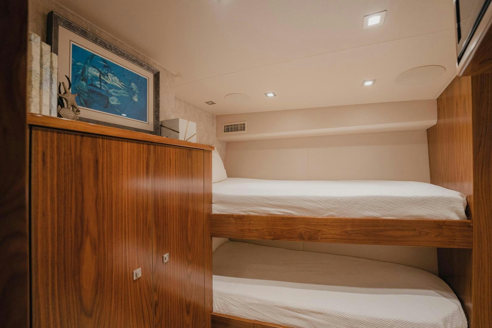 a room with a bed and a television on the wall aboard AUSPICIOUS Yacht for Sale