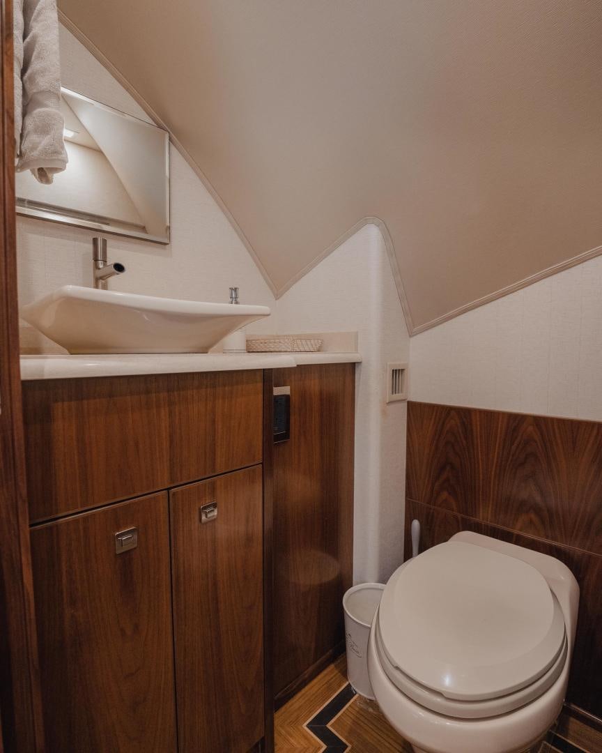 a bathroom with a sink and a toilet aboard AUSPICIOUS Yacht for Sale