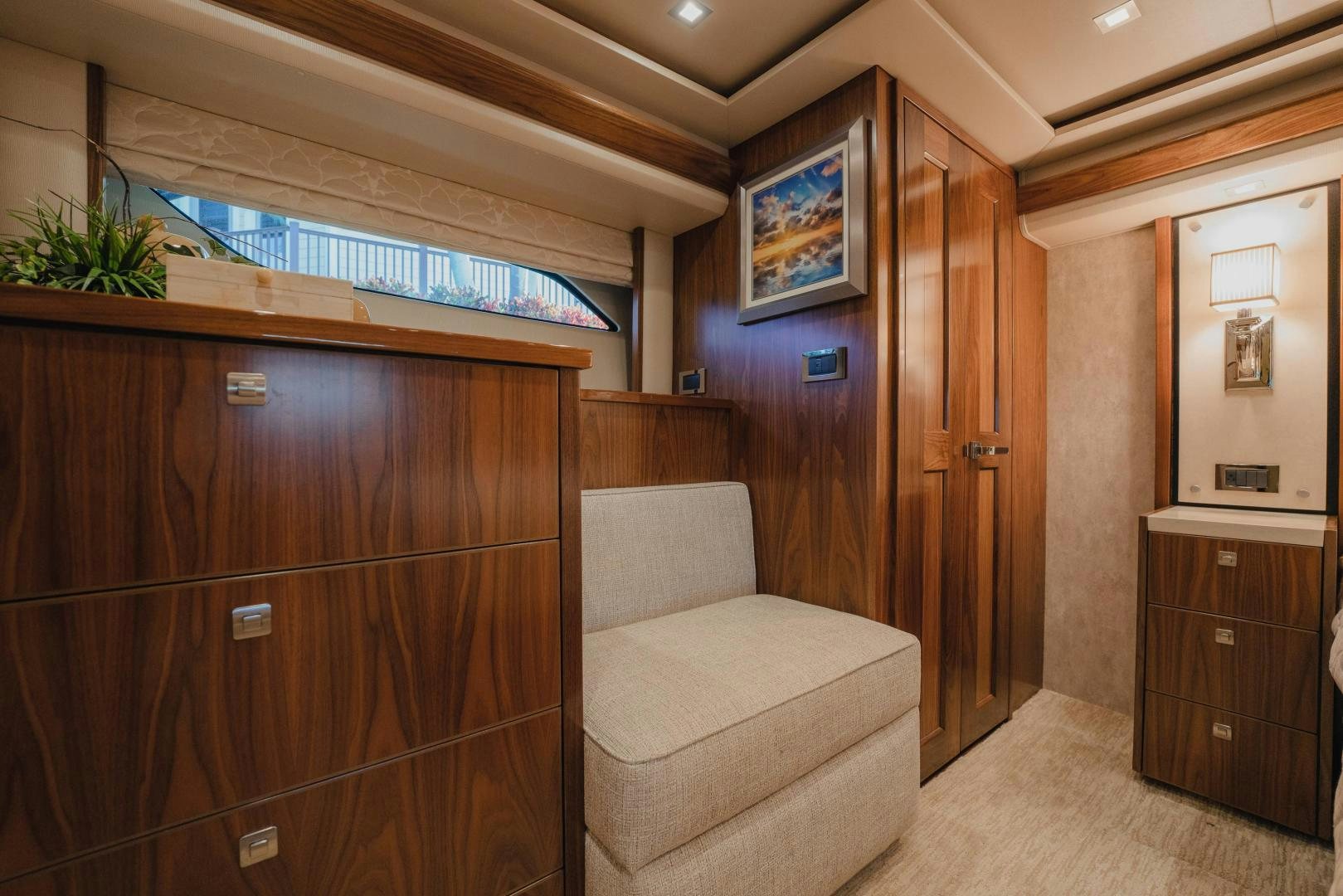 a living room with a couch and a wood cabinet aboard AUSPICIOUS Yacht for Sale