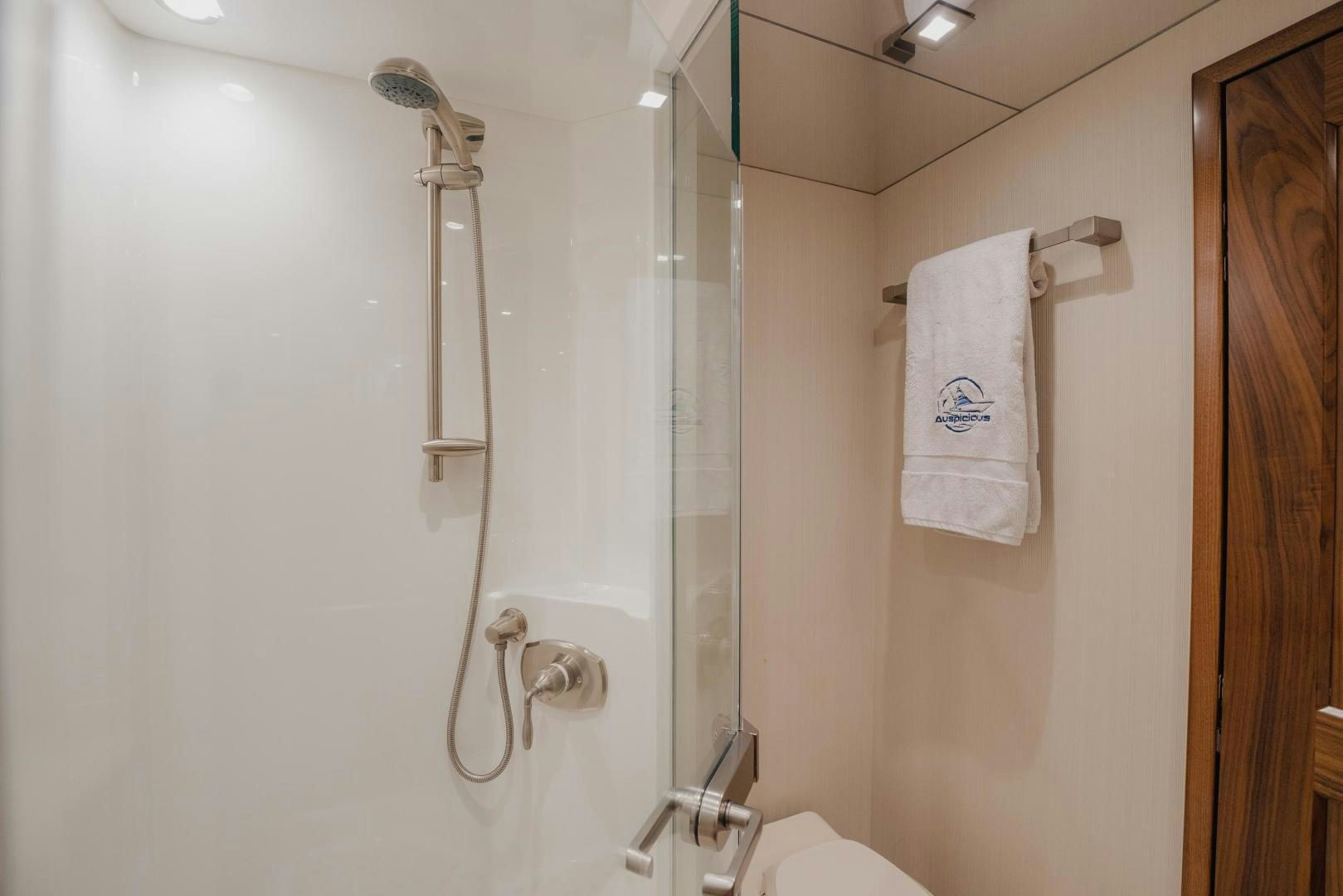 a bathroom with a shower and a sink aboard AUSPICIOUS Yacht for Sale