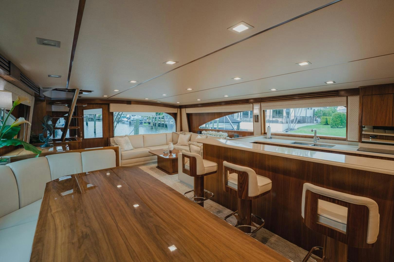 a large room with a wood table and chairs aboard AUSPICIOUS Yacht for Sale