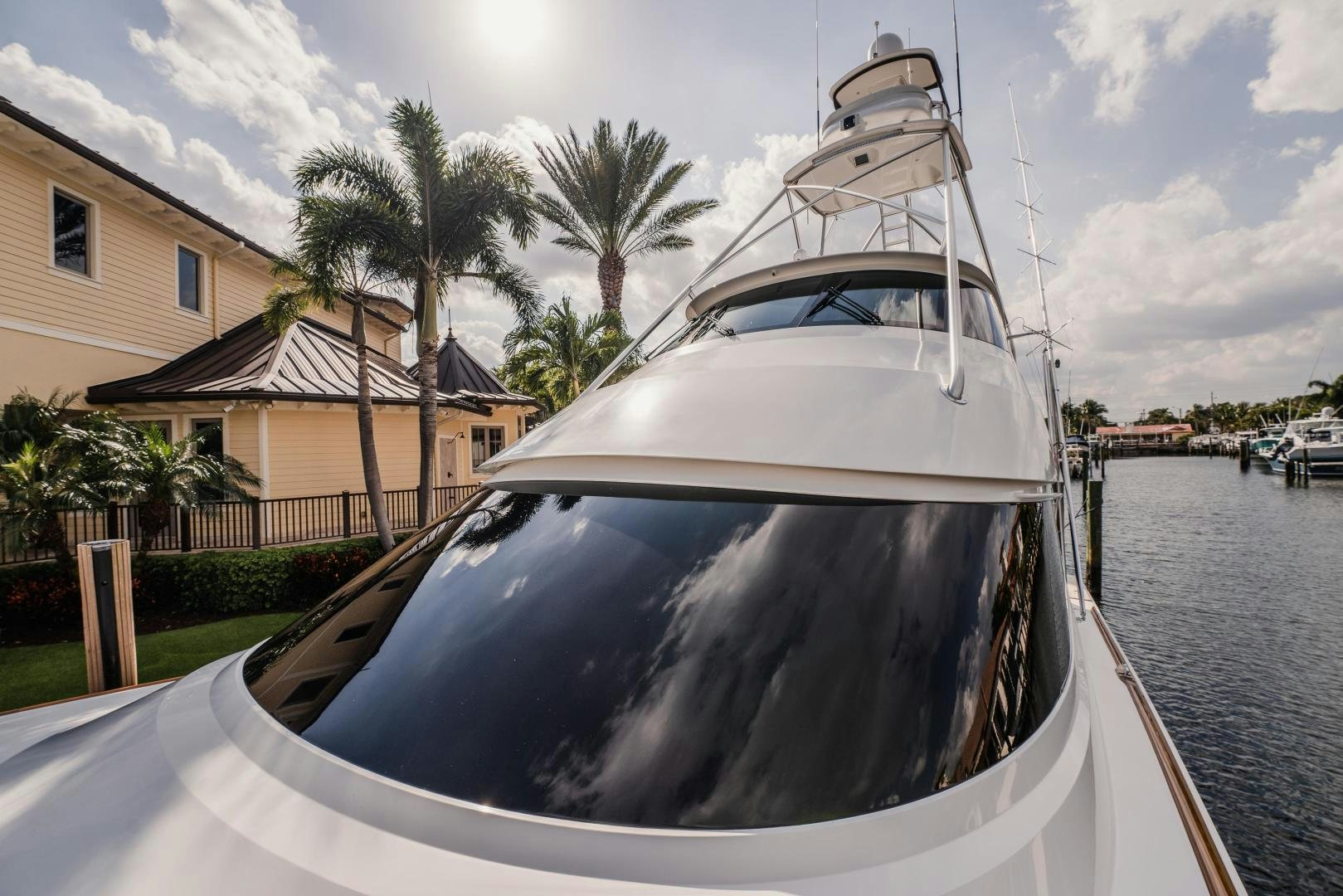 a white boat in a harbor aboard AUSPICIOUS Yacht for Sale