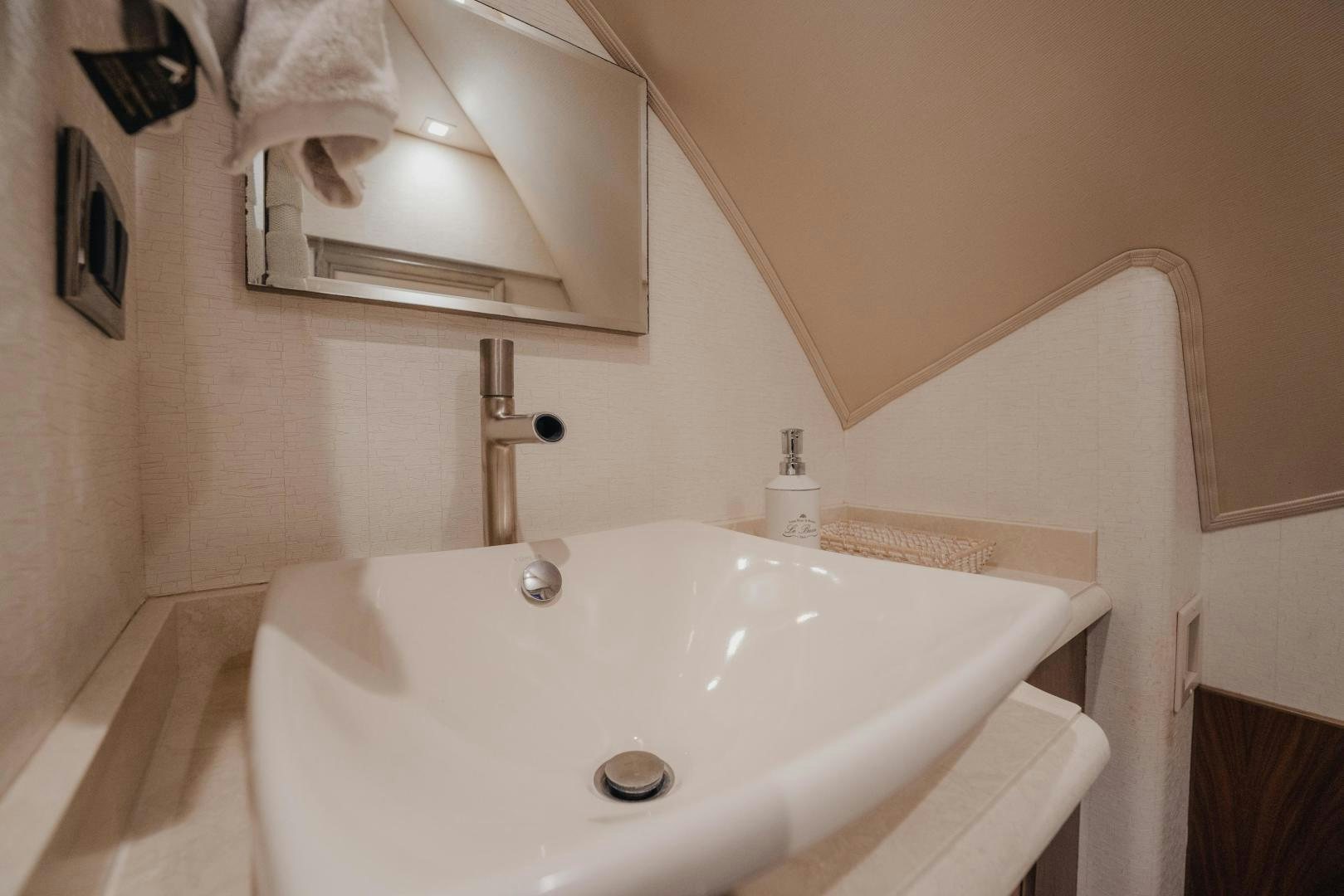 a sink with a mirror above it aboard AUSPICIOUS Yacht for Sale
