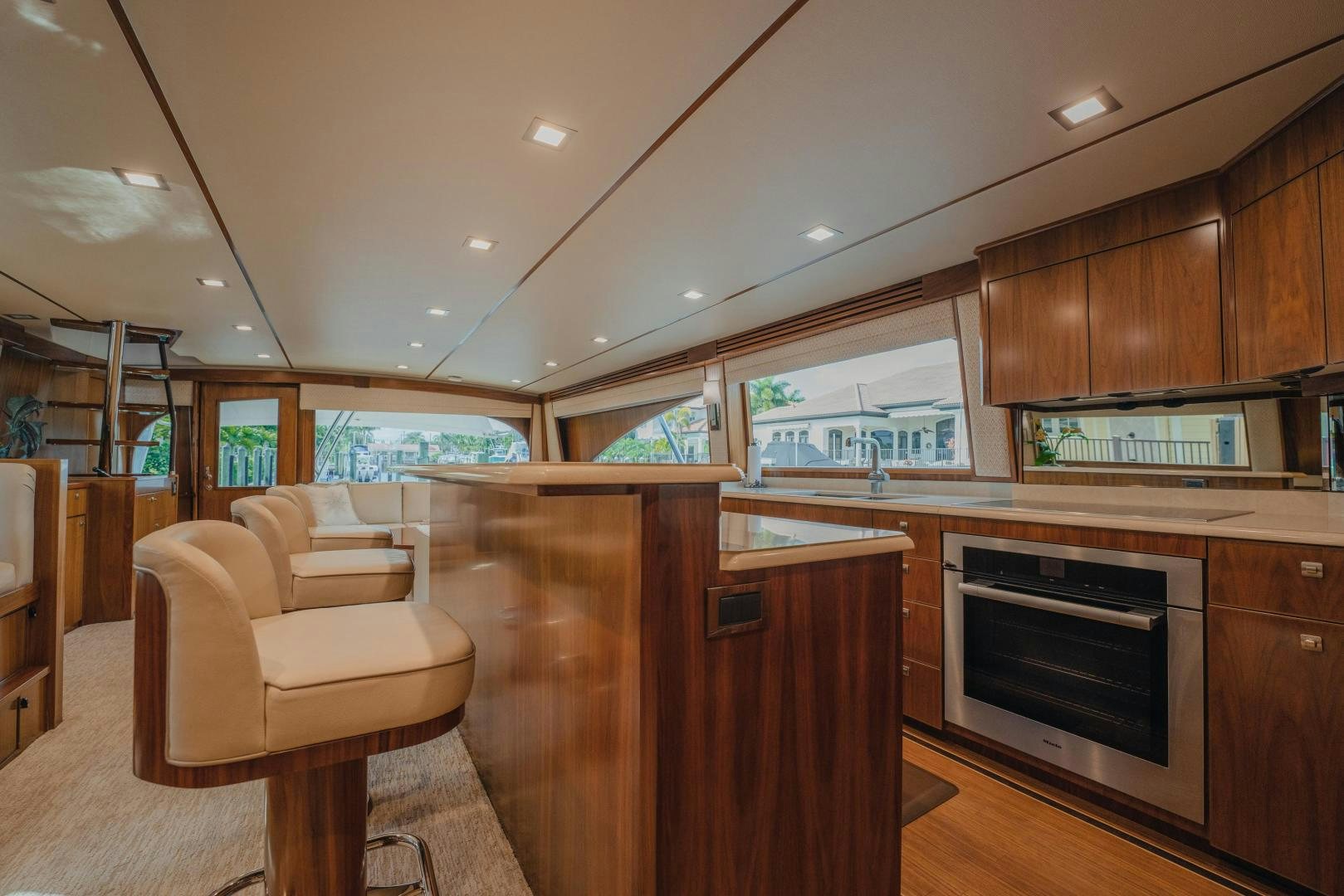 a kitchen with wooden cabinets aboard AUSPICIOUS Yacht for Sale