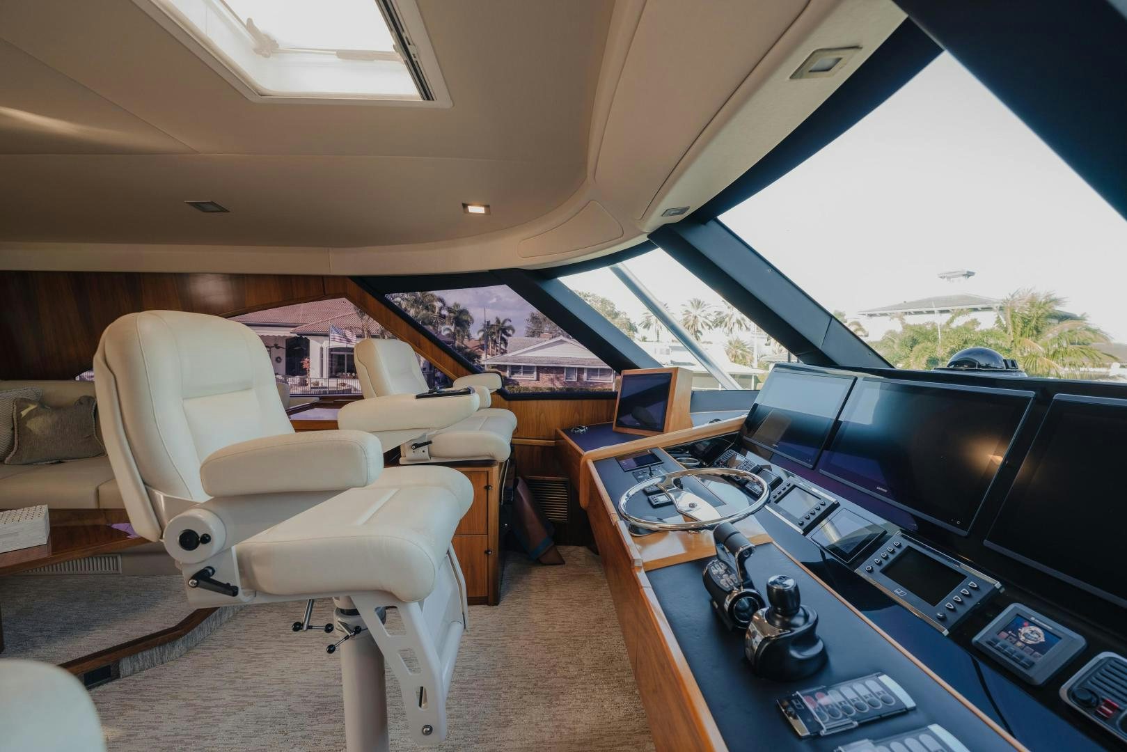 inside of a vehicle with a large screen and a desk with a computer and a television on it aboard AUSPICIOUS Yacht for Sale