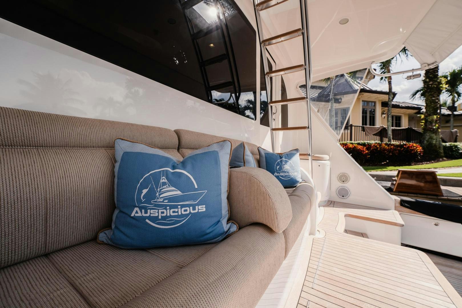 a bed with a blue pillow on it aboard AUSPICIOUS Yacht for Sale