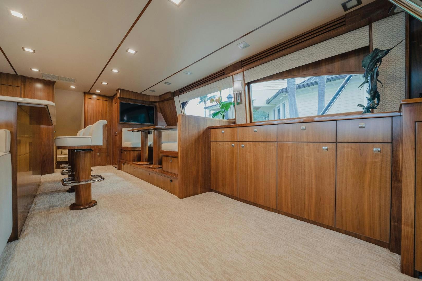 a room with a wood floor and a large window aboard AUSPICIOUS Yacht for Sale