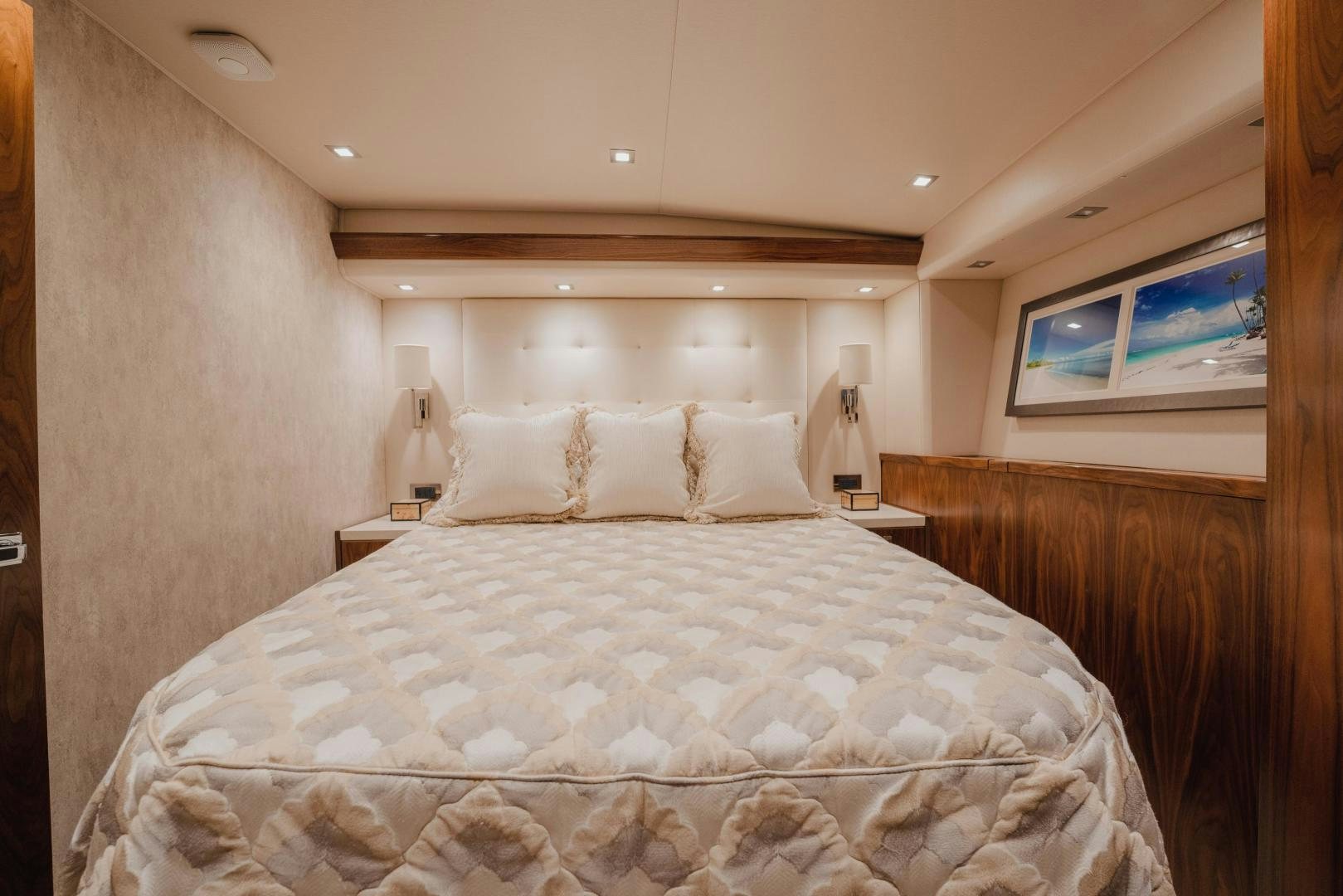 a bed with a white comforter aboard AUSPICIOUS Yacht for Sale