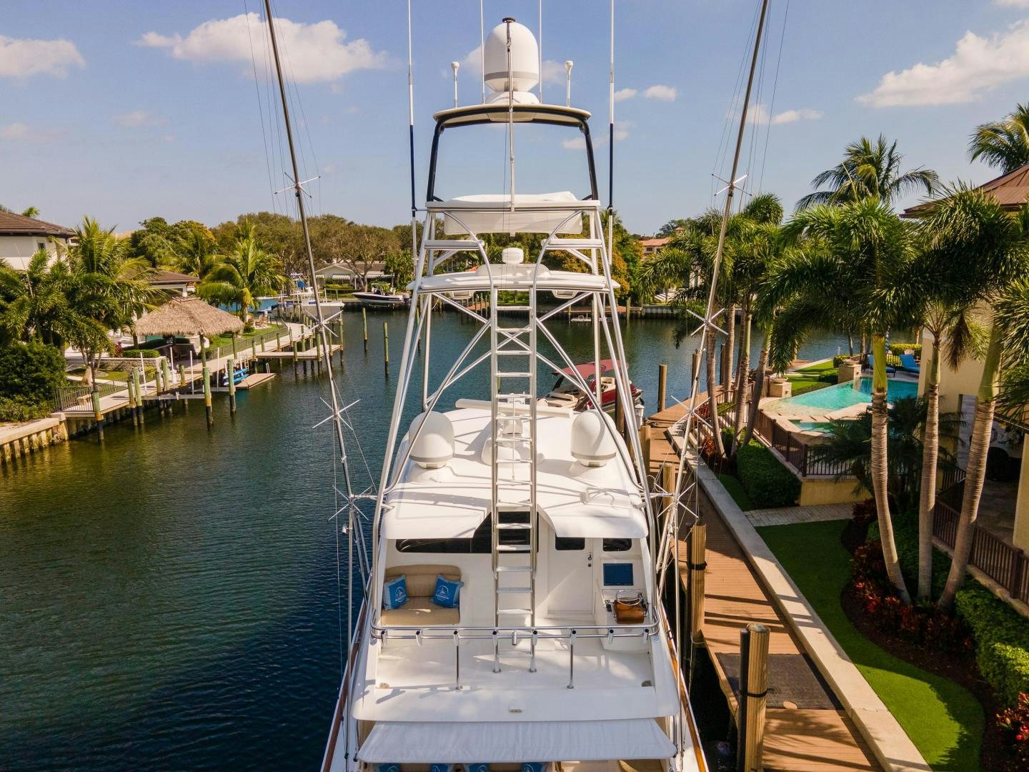a white boat docked at a pier aboard AUSPICIOUS Yacht for Sale