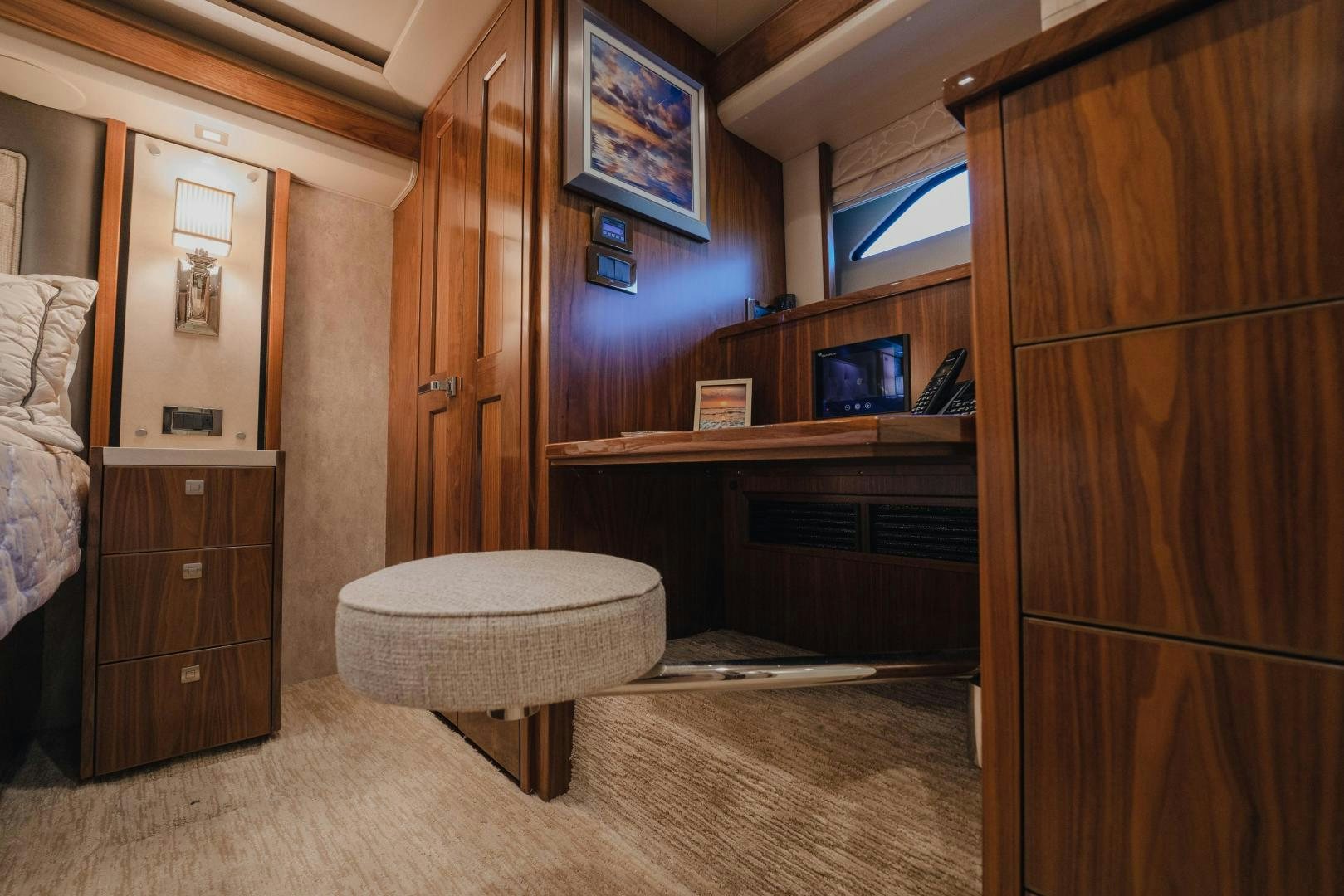 a room with a wood cabinet and a round table aboard AUSPICIOUS Yacht for Sale