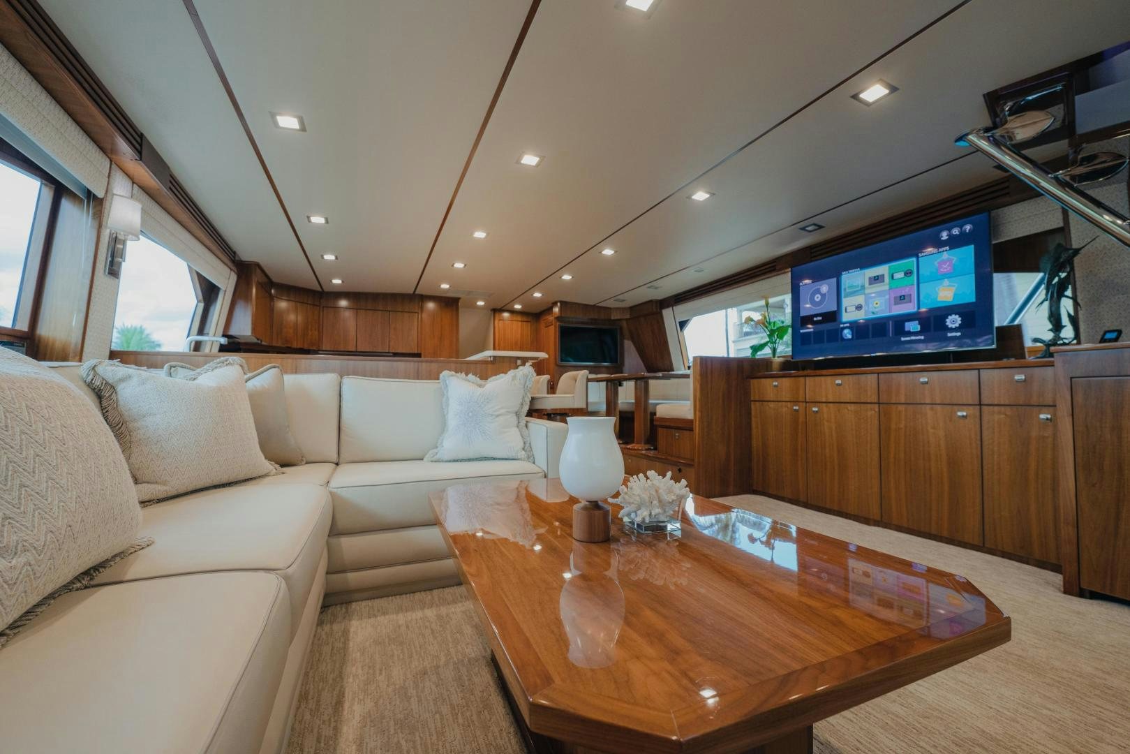 a living room with a table and tv aboard AUSPICIOUS Yacht for Sale