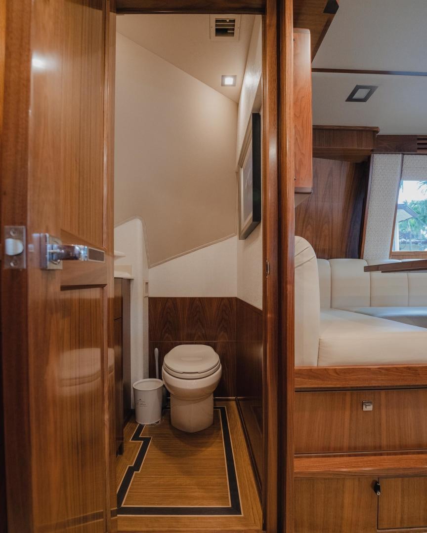 a bathroom with a toilet and a sink aboard AUSPICIOUS Yacht for Sale