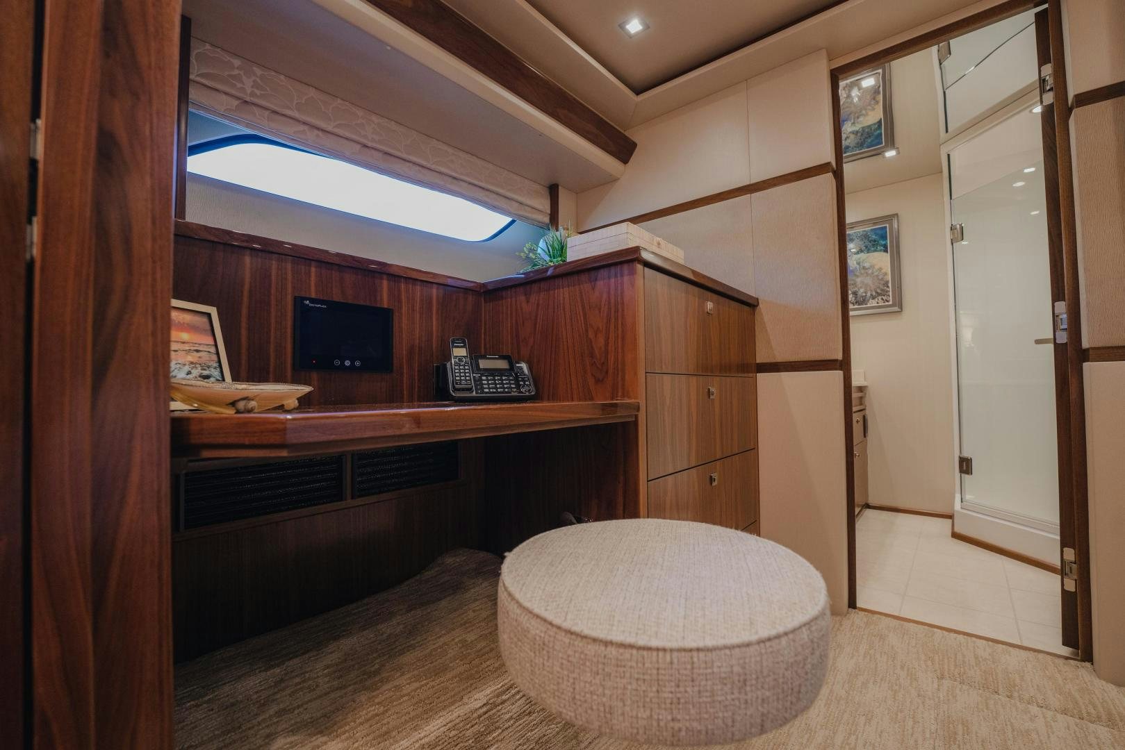 a room with a round table and a television aboard AUSPICIOUS Yacht for Sale