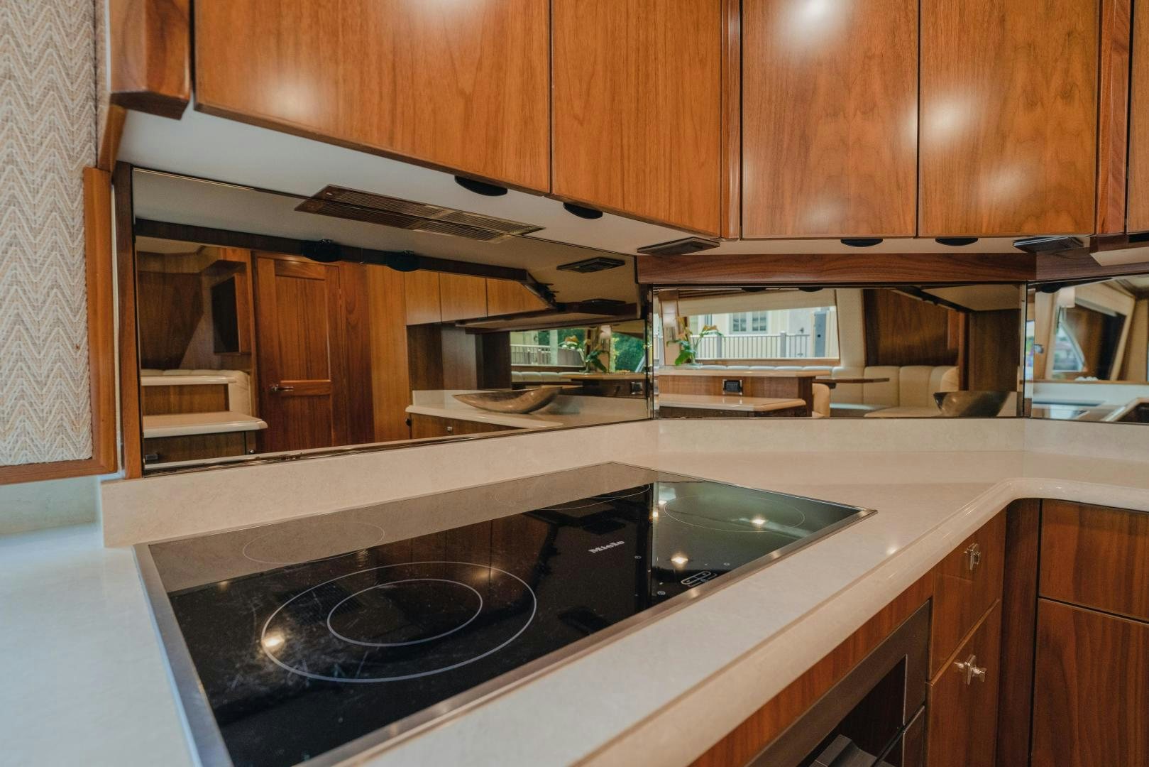 a kitchen with wooden cabinets aboard AUSPICIOUS Yacht for Sale