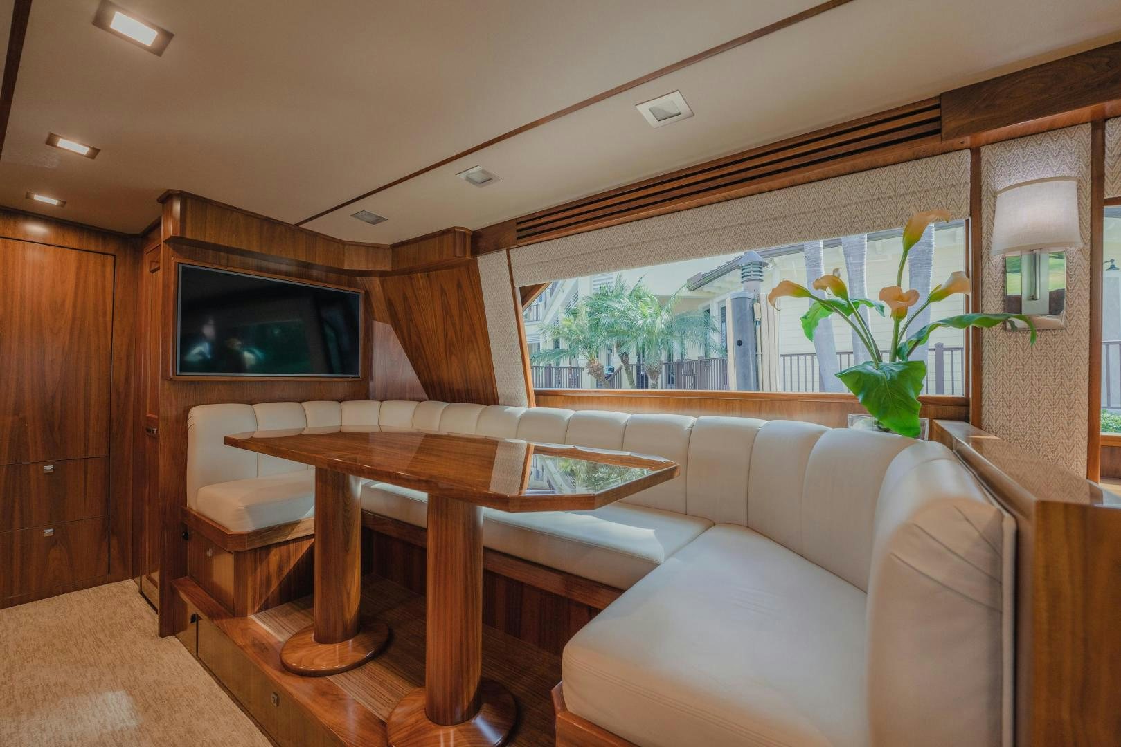 a living room with a table and couches aboard AUSPICIOUS Yacht for Sale