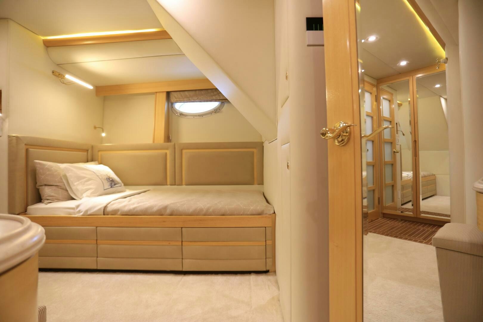 a bedroom with a bed and a closet aboard FORTY LOVE Yacht for Sale