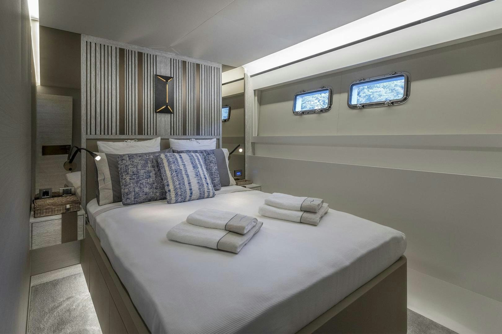 a bed with a white bed spread aboard 26XP HULL 24 Yacht for Sale