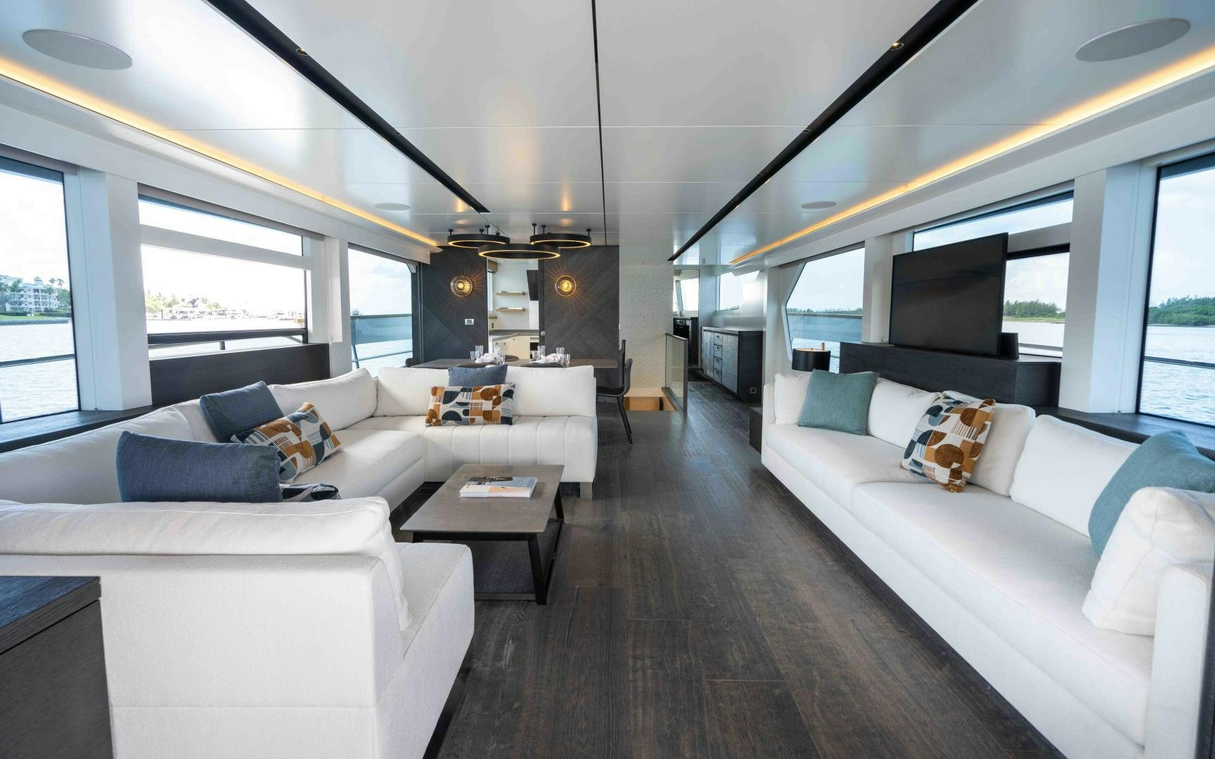a living room with a large window aboard C3 Yacht for Sale