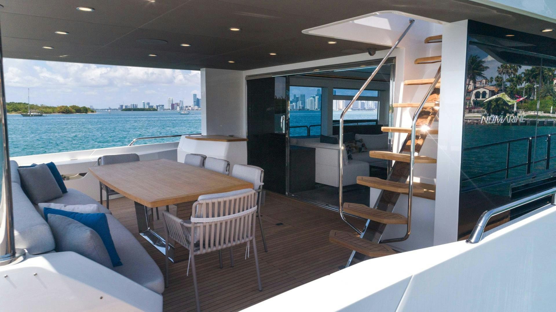 a room with a table chairs and a view of the water aboard C3 Yacht for Sale