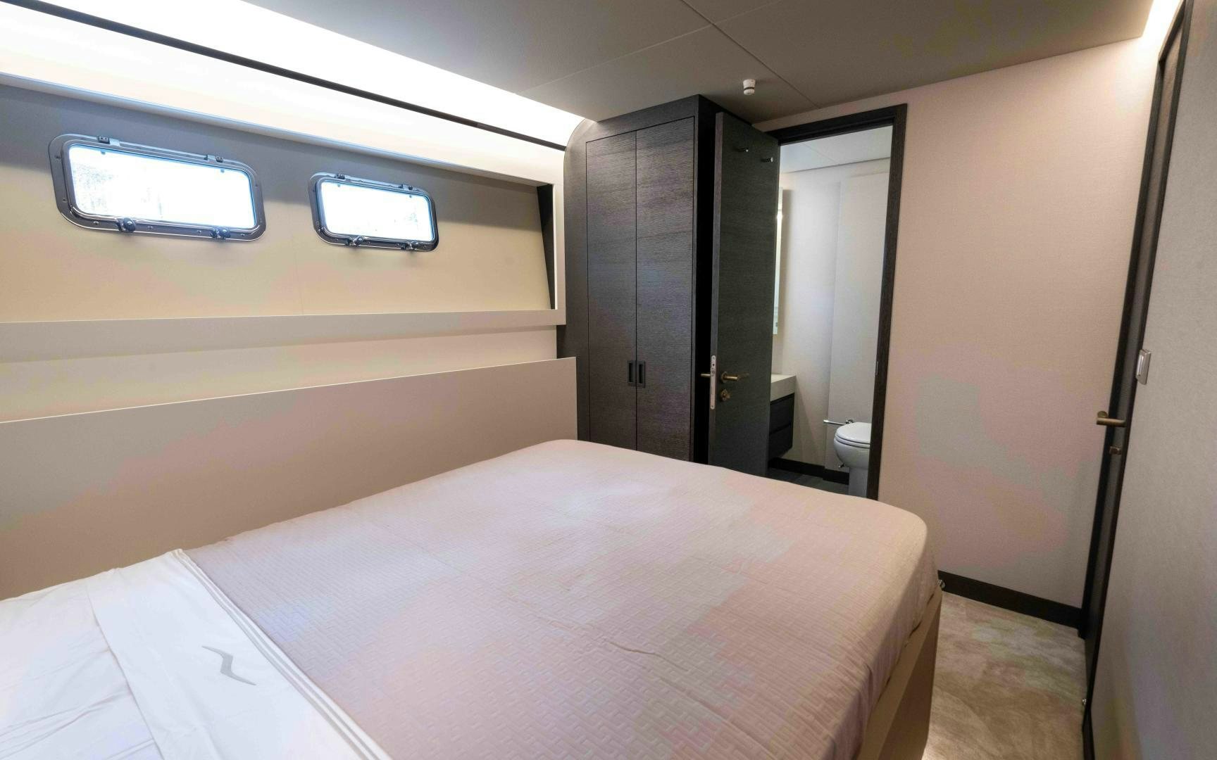 a room with a bed and a window aboard C3 Yacht for Sale