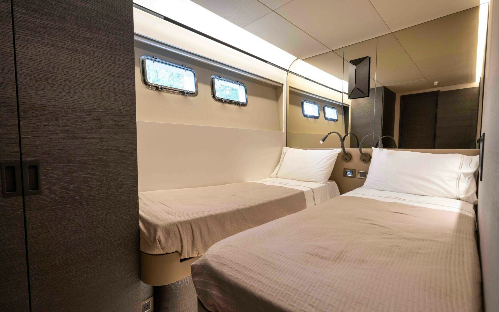 a room with a bed and a television aboard C3 Yacht for Sale