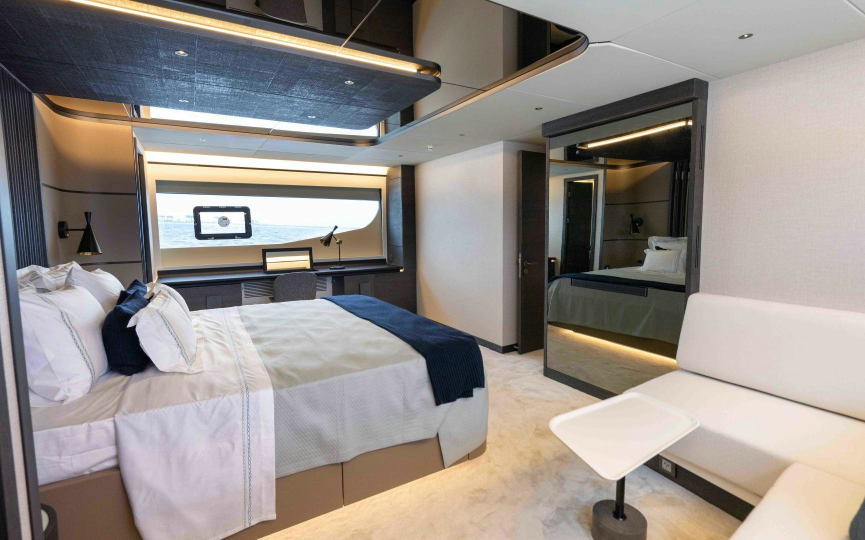 a room with a bed and a chair aboard C3 Yacht for Sale