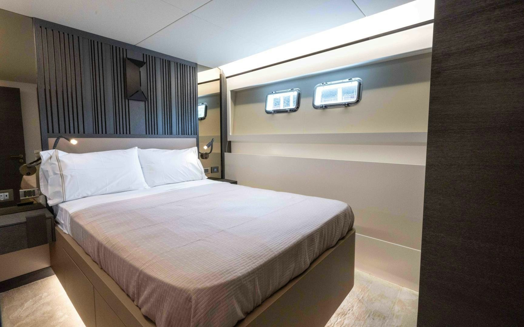 a bedroom with a bed and a desk aboard C3 Yacht for Sale