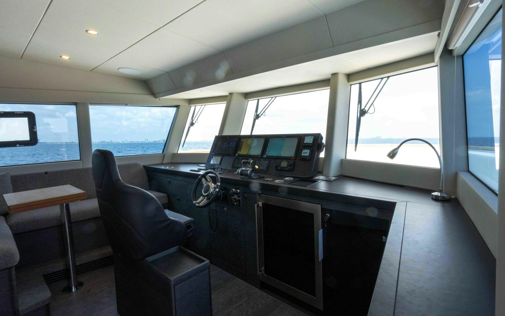 a kitchen with a bar and chairs aboard C3 Yacht for Sale