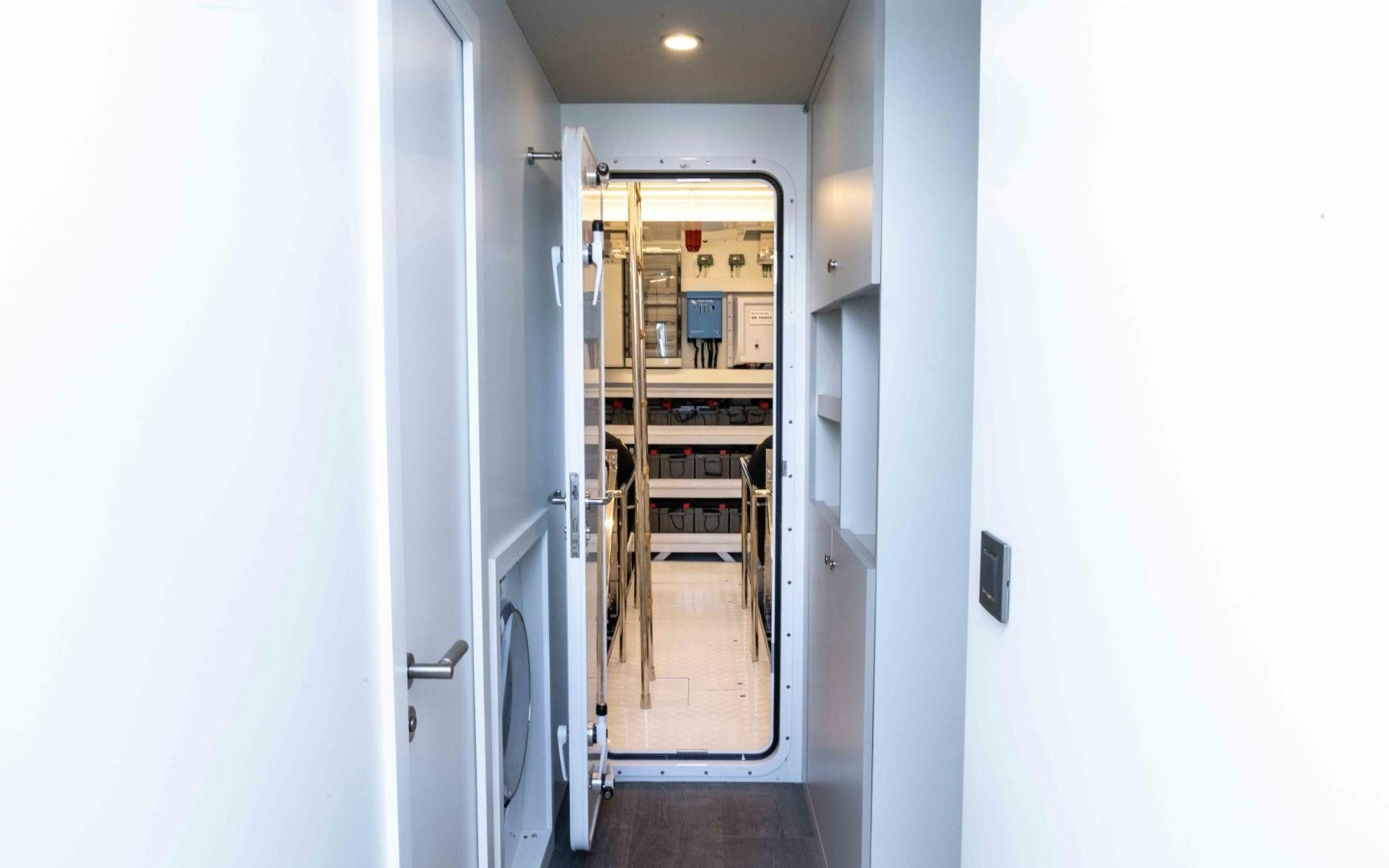 a hallway with a door and a ladder aboard C3 Yacht for Sale