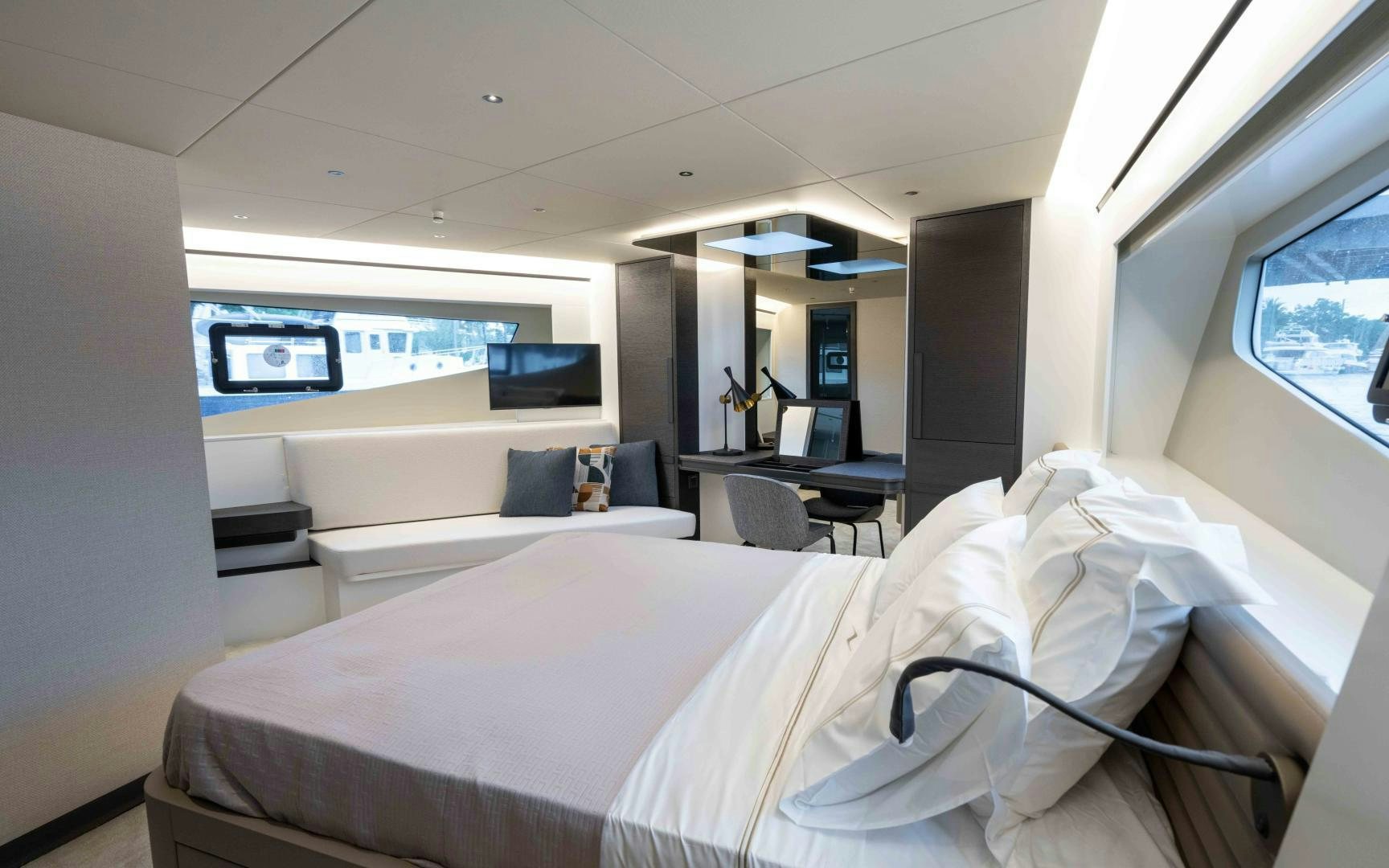 a room with a bed and a desk aboard C3 Yacht for Sale