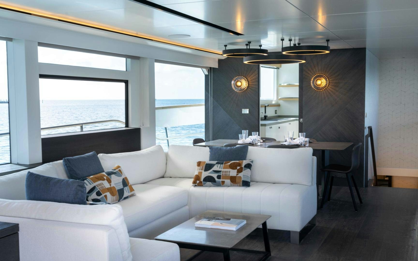 a living room with a white couch and a large window aboard C3 Yacht for Sale