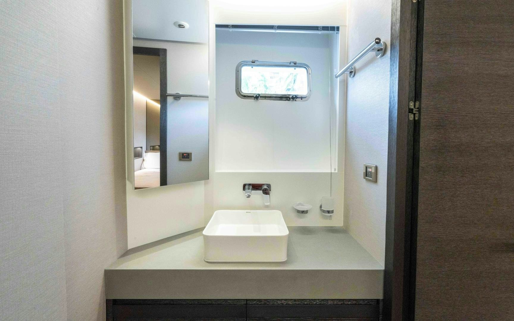 a bathroom with a sink and a mirror aboard C3 Yacht for Sale