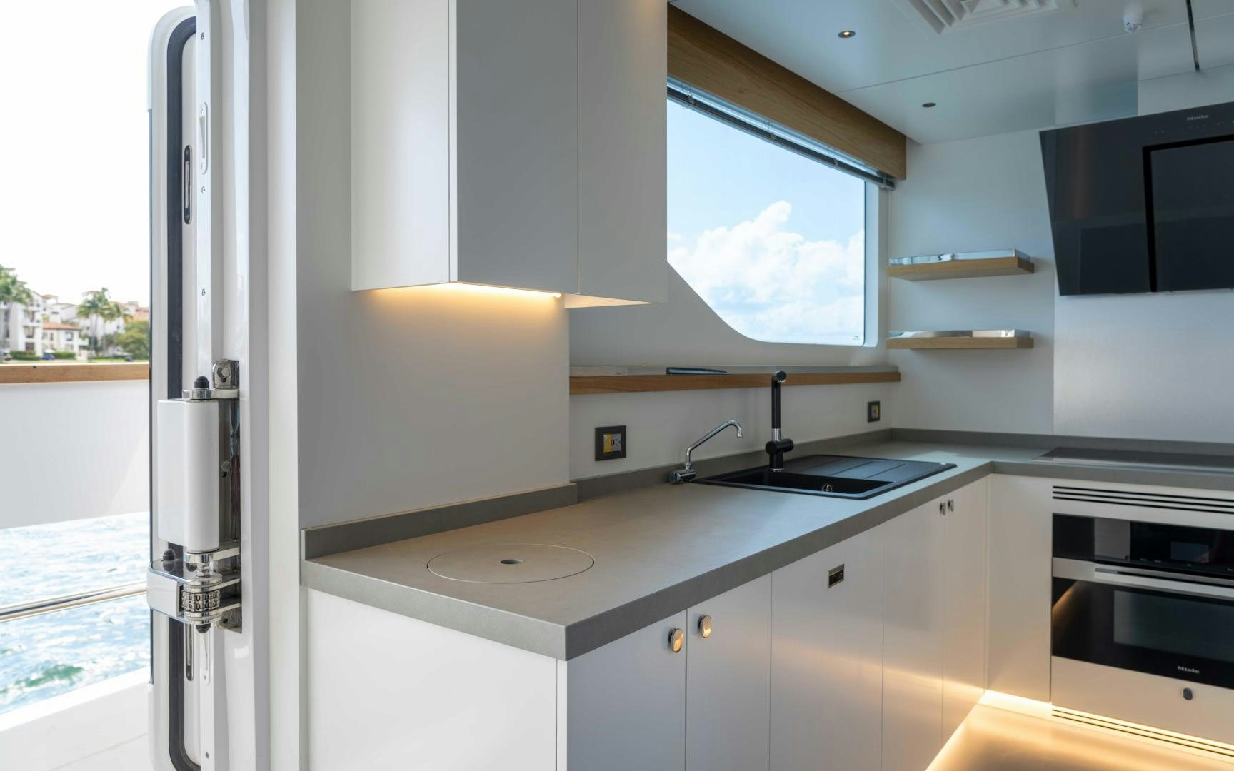 a kitchen with white cabinets aboard C3 Yacht for Sale