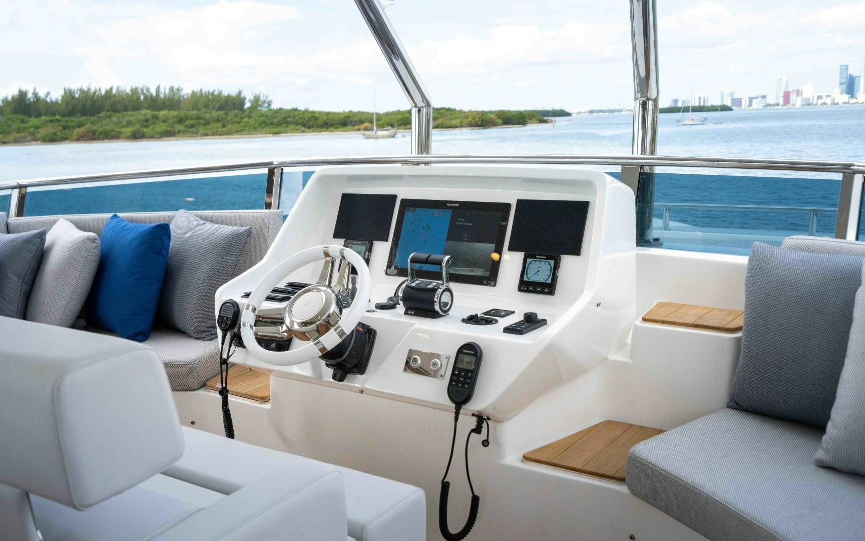 a white car with a screen and a remote control on the dashboard aboard C3 Yacht for Sale