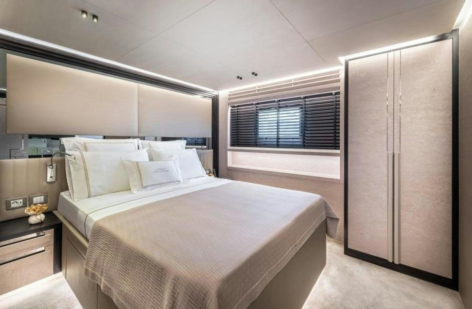 a bedroom with a bed and a window aboard NUMARINE 37XP 17 Yacht for Sale