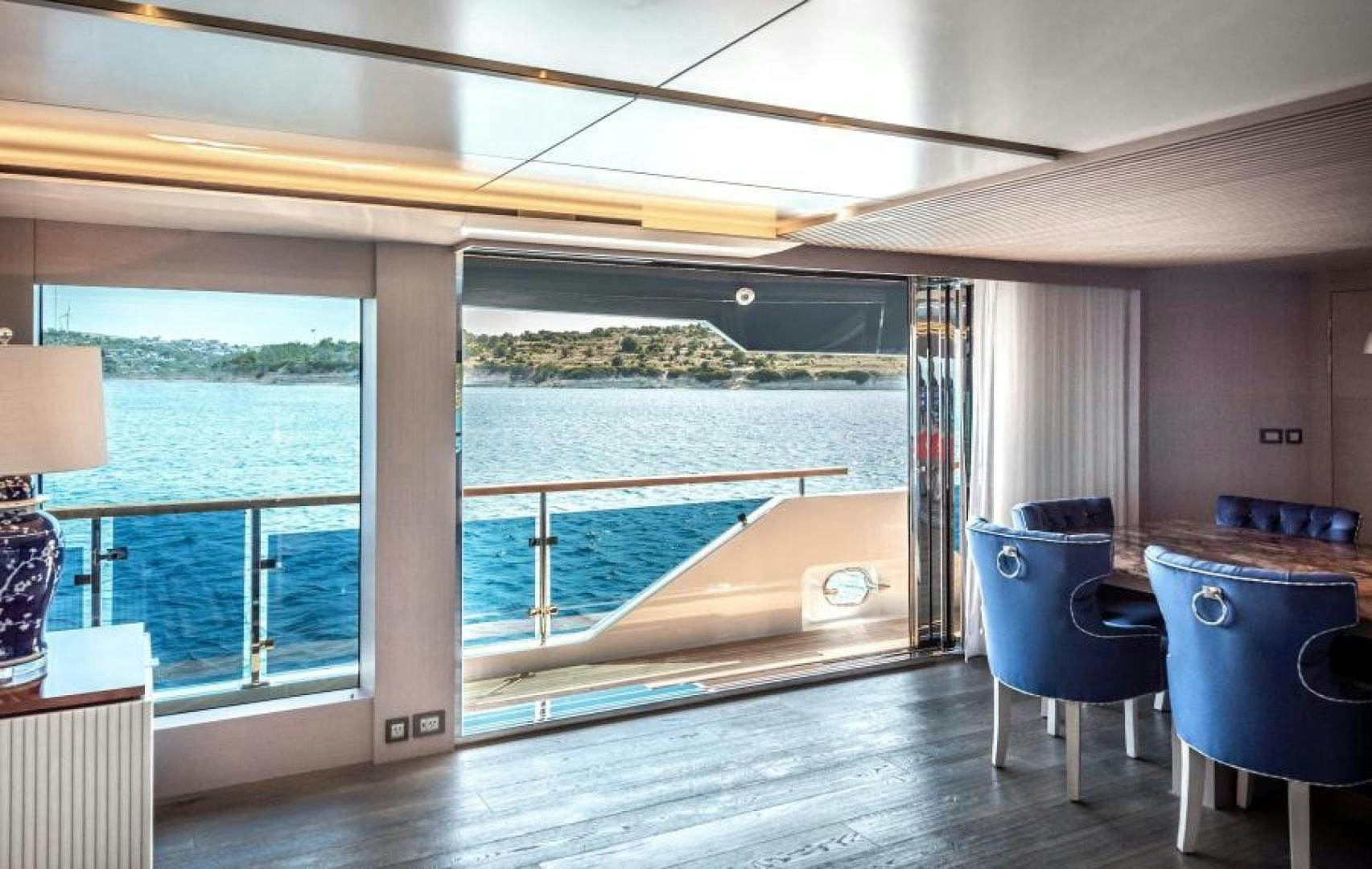 a room with a table and chairs and a large window aboard NUMARINE 37XP 17 Yacht for Sale