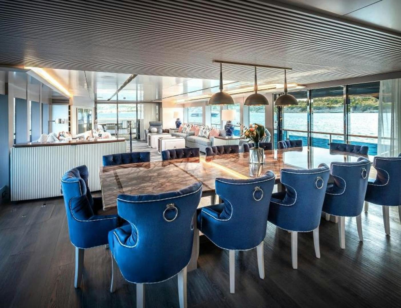 a room with tables and chairs aboard NUMARINE 37XP 17 Yacht for Sale