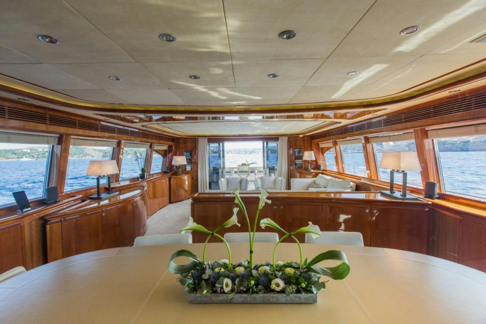 a plant in a pot on a table in a room with windows aboard CHAMPAGNE & CAVIAR Yacht for Sale