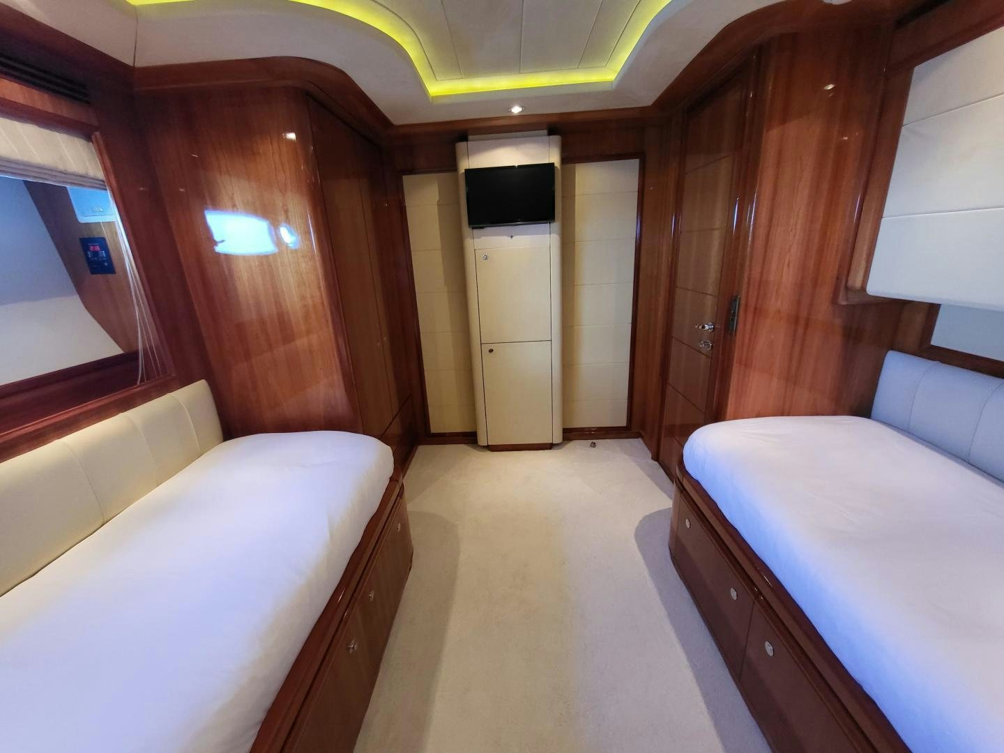 a room with a bed and a television aboard CHAMPAGNE & CAVIAR Yacht for Sale