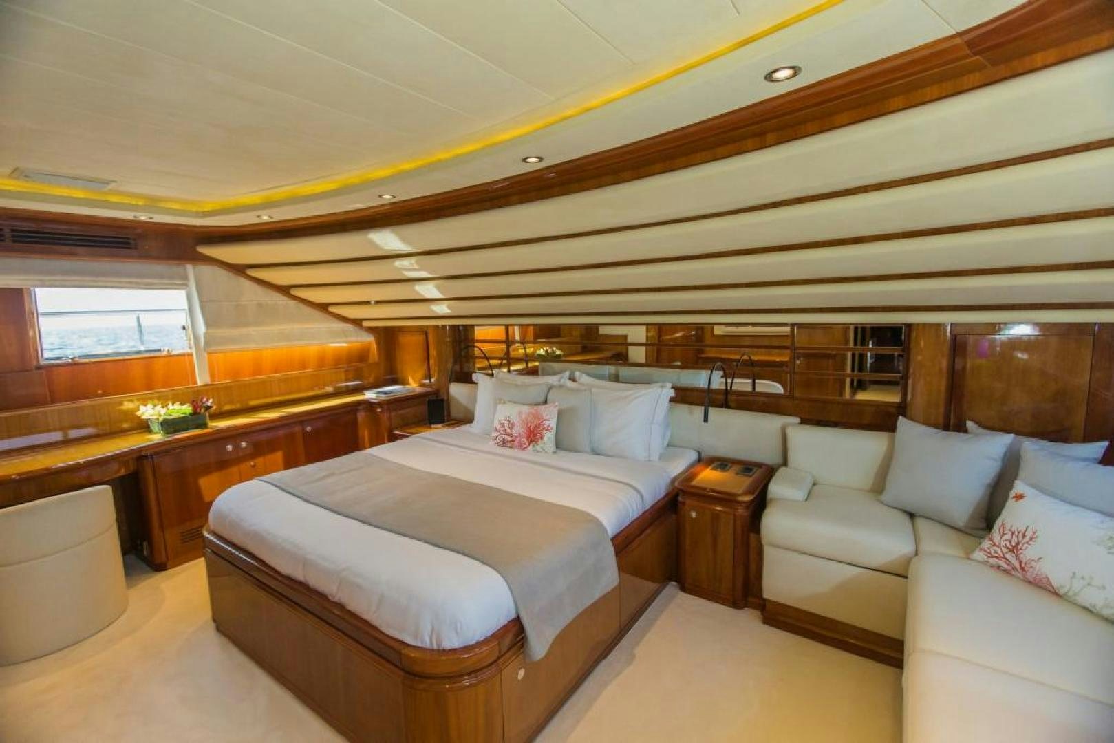 a room with a bed and a couch aboard CHAMPAGNE & CAVIAR Yacht for Sale