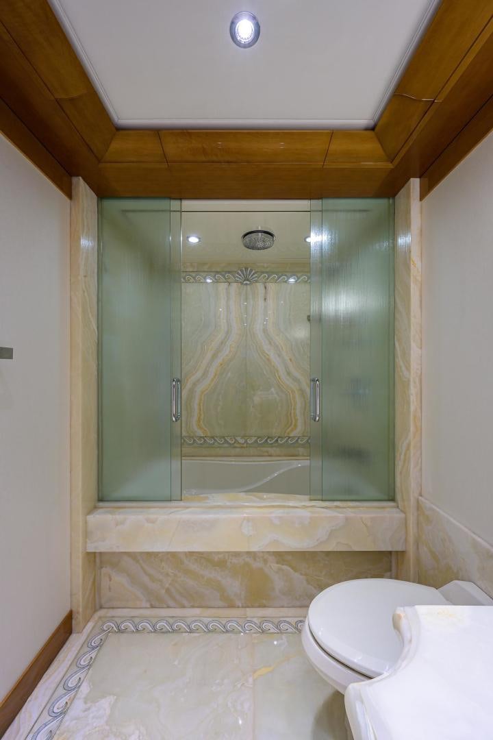 a bathroom with a glass shower aboard SEANASH Yacht for Sale
