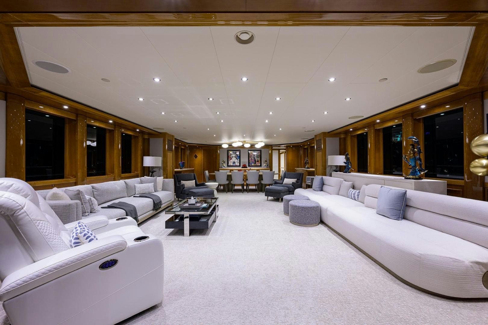 a room with white couches and a large mirror aboard SEANASH Yacht for Sale