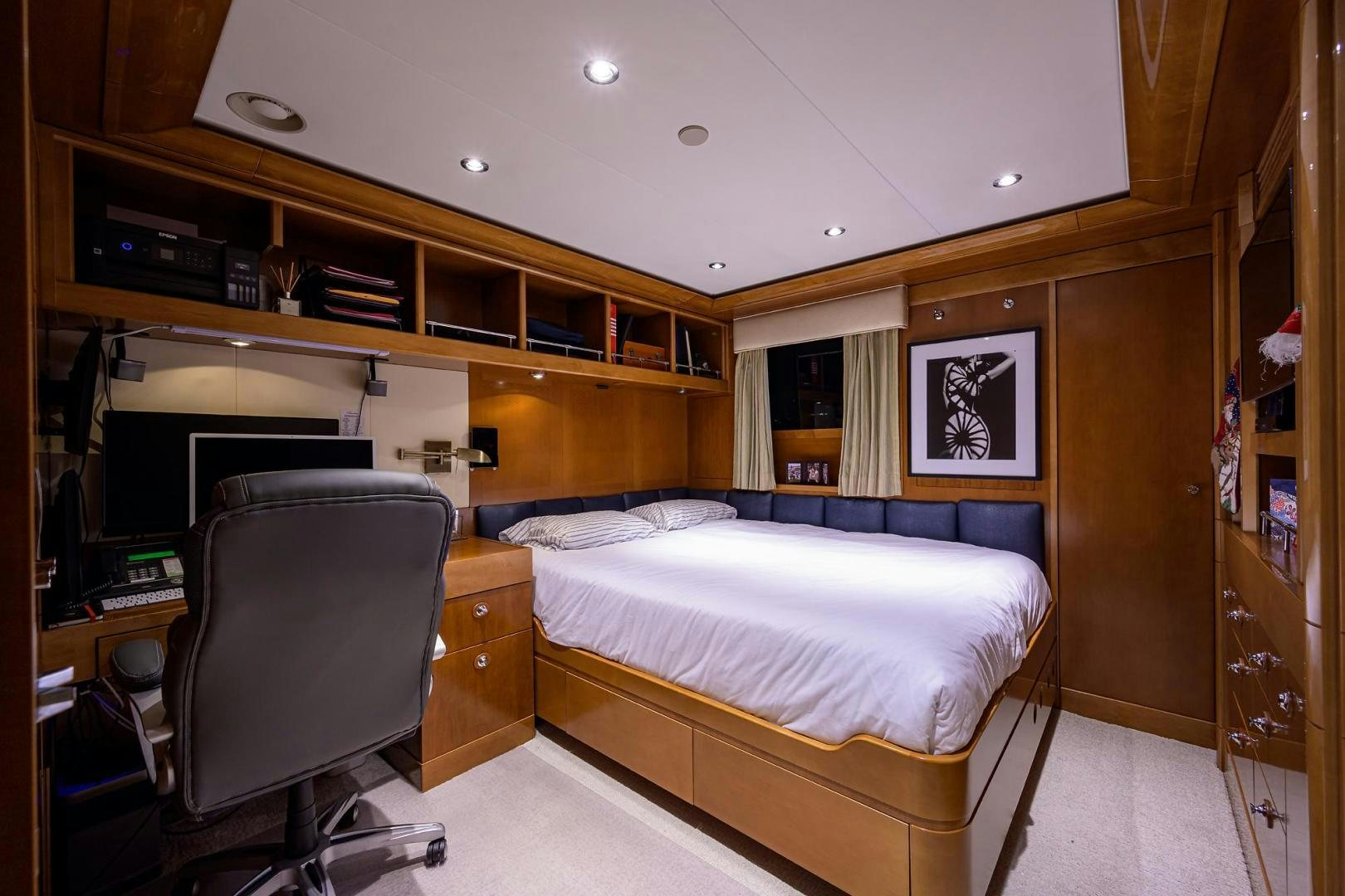 a bedroom with a bed and desk aboard SEANASH Yacht for Sale