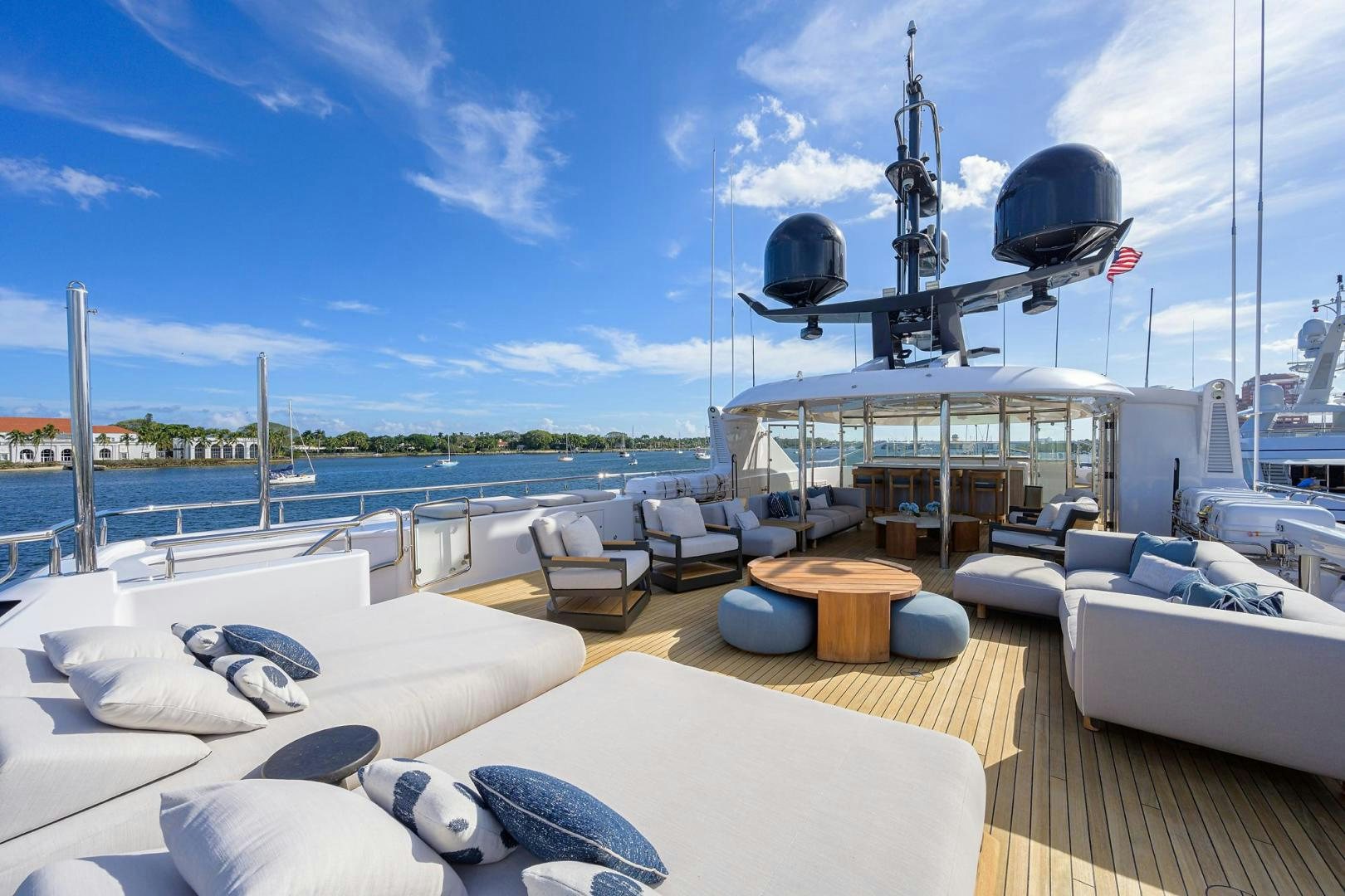 a deck with a large boat in the background aboard SEANASH Yacht for Sale