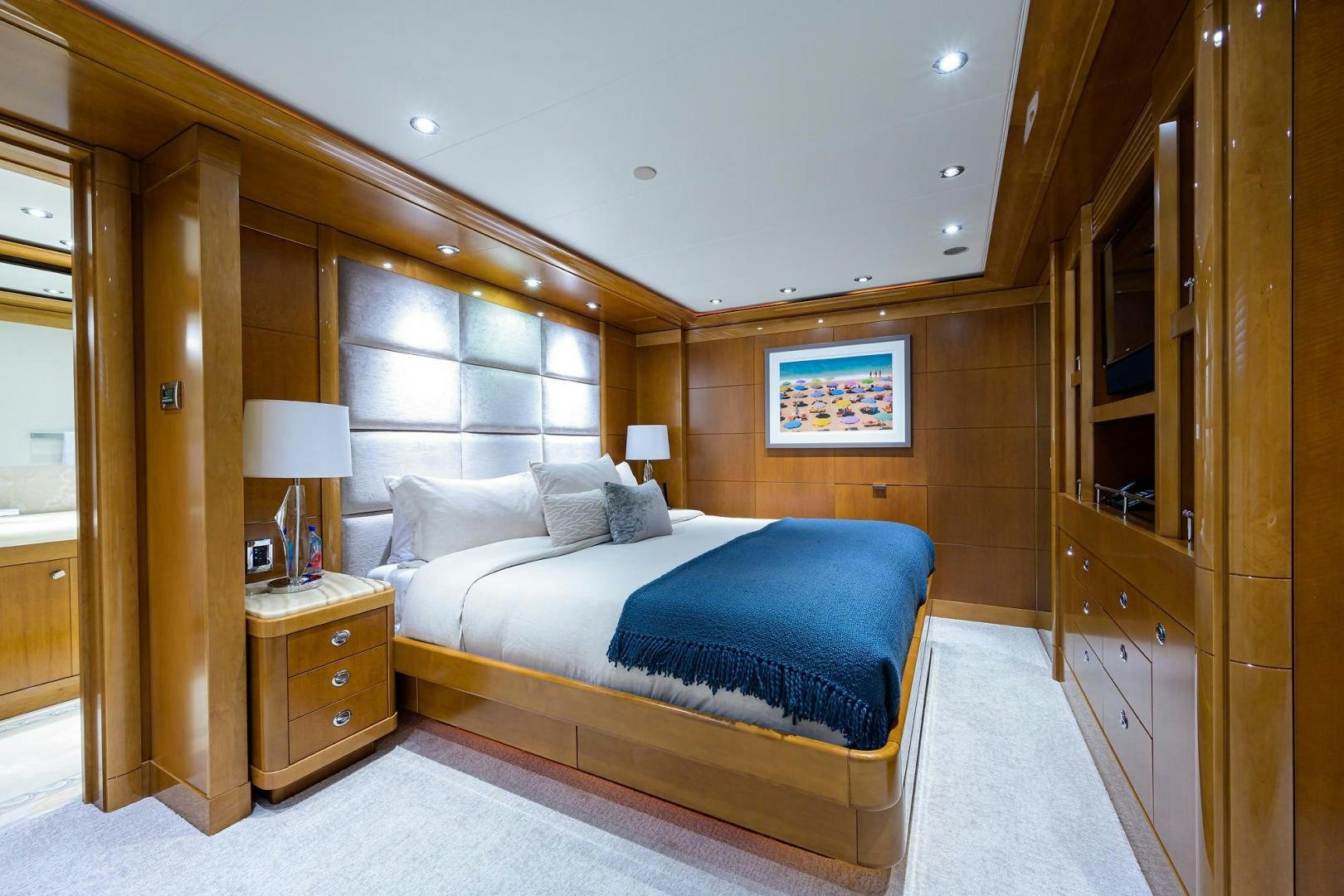 a bedroom with a bed and a desk aboard SEANASH Yacht for Sale