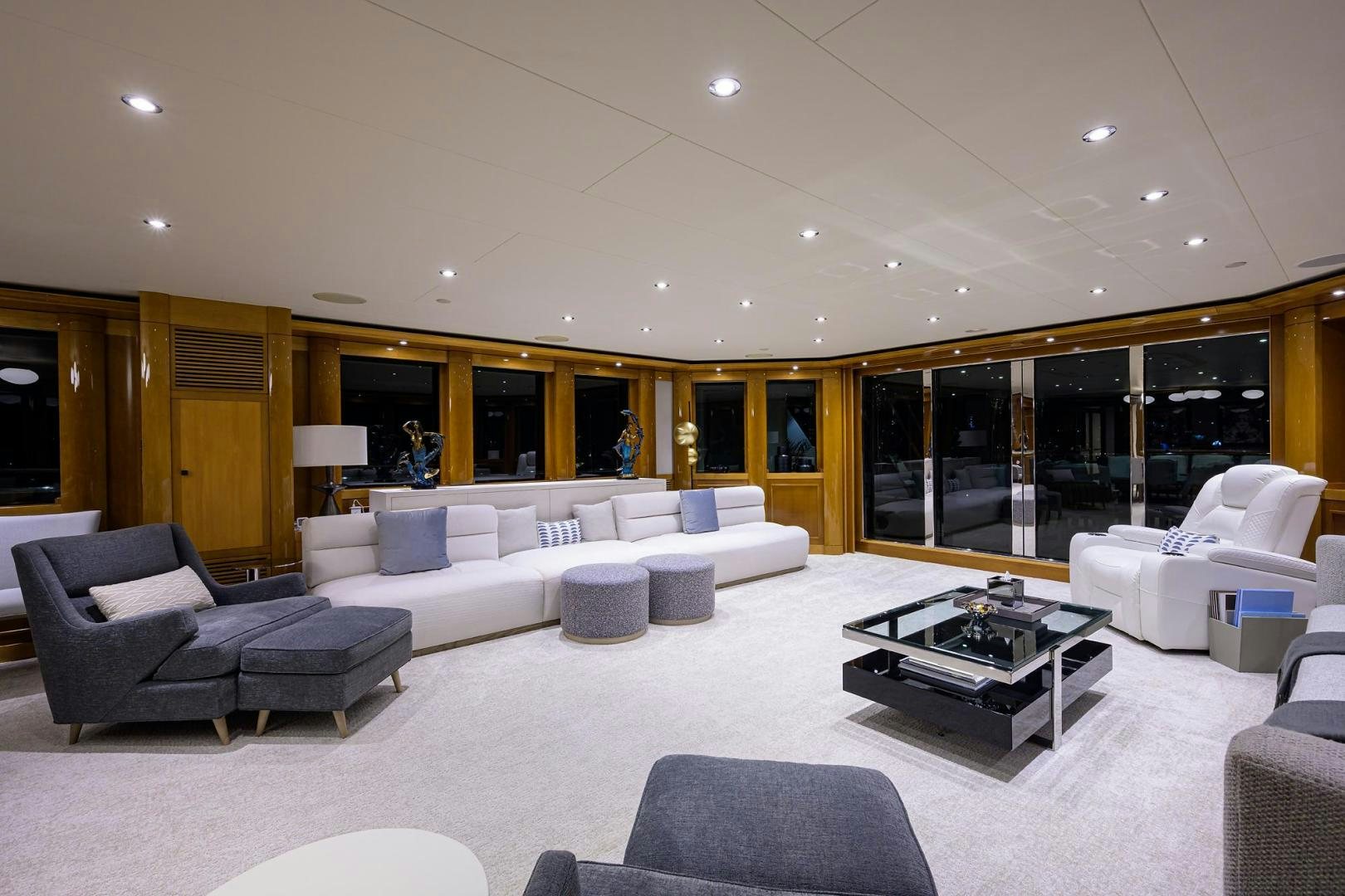 a large living room with white couches and a coffee table aboard SEANASH Yacht for Sale
